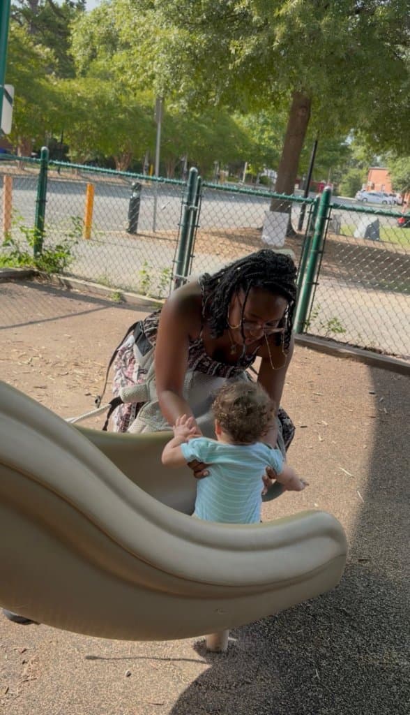 Helping a little one down the slide
